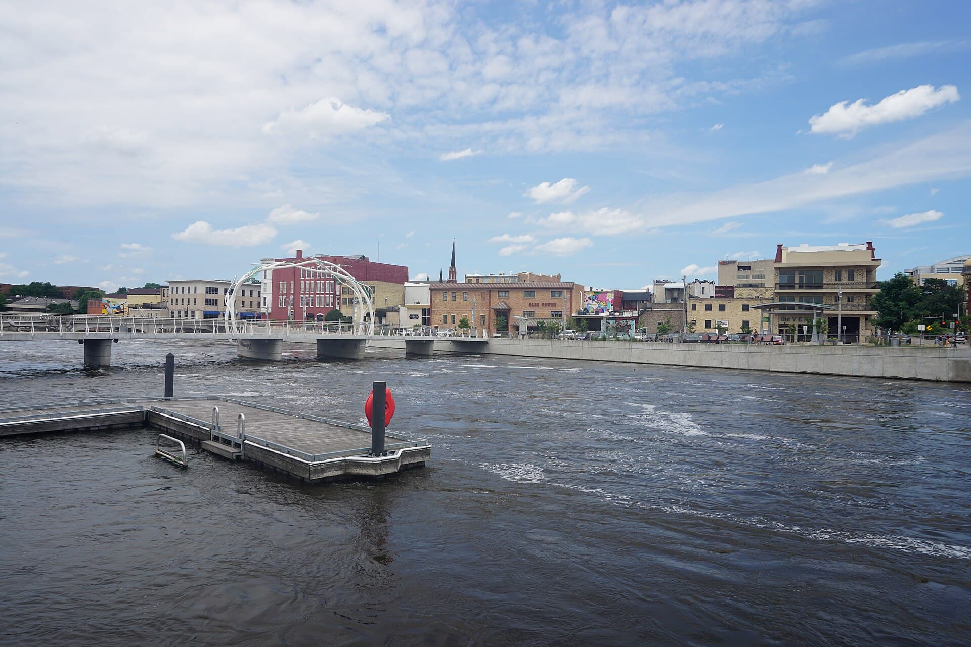 Rock River flowing through downtown Janesville with bridge and church steeple